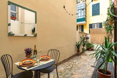 a table with chairs and a bottle of wine on a patio at Green Central Rome Escape in Rome