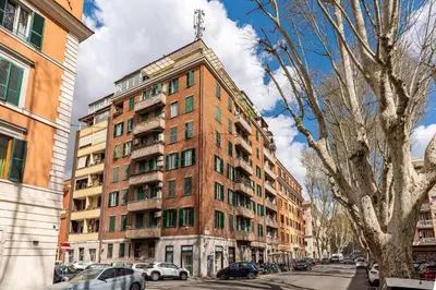 a tall red brick building on a city street at Green Central Rome Escape in Rome