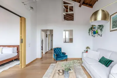a living room with a couch and a table at Hostly-Light and Wood Rome Midtown-Near Trevi in Rome