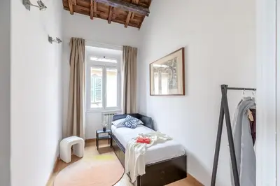 a small room with a bed and a window at Hostly-Light and Wood Rome Midtown-Near Trevi in Rome