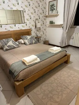 a bedroom with a bed with two towels on it at Retroflatsanlorenzo in Rome