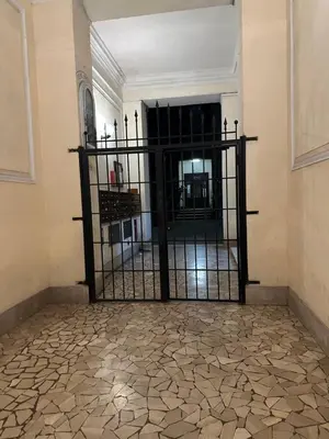an iron gate in a room with a fireplace at Retroflatsanlorenzo in Rome
