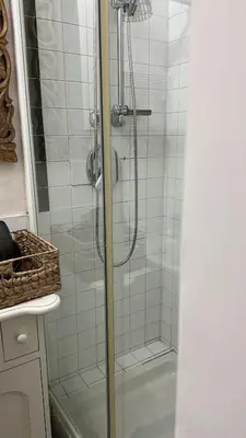 a shower with a glass door in a bathroom at Retroflatsanlorenzo in Rome