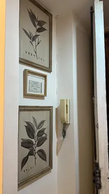 a hallway with two pictures on the wall and a light at Retroflatsanlorenzo in Rome