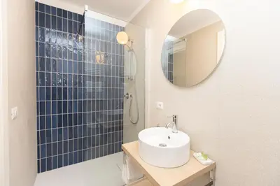 a bathroom with a sink and a shower with a mirror at Vatican Colors Rooms in Rome