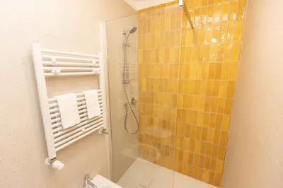 a bathroom with a shower with a glass door at Vatican Colors Rooms in Rome