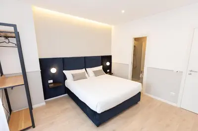a bedroom with a white bed in a room at Vatican Colors Rooms in Rome