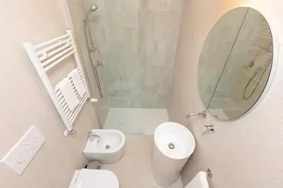 a bathroom with a sink and a toilet and a mirror at Vatican Colors Rooms in Rome