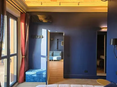 a room with a blue wall with a mirror at Train Station in Rome