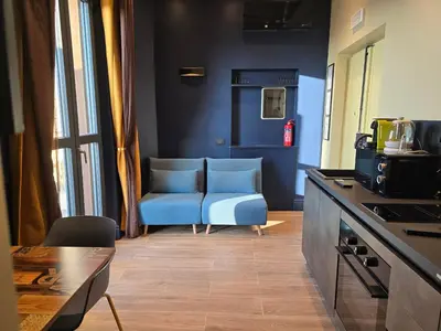 a kitchen with a blue chair and a table at Train Station in Rome