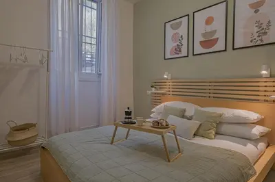 a bedroom with a bed with a table on it at B&F Home Vatican Stay in Rome