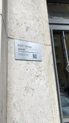 a keep home sign on the side of a building at B&F Home Vatican Stay in Rome