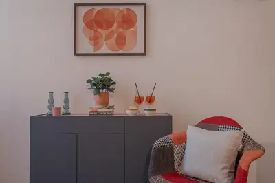 a living room with a chair and a cabinet at B&F Home Vatican Stay in Rome