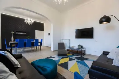 a living room with a couch and a table at Iron Apartment Santa Maria in Rome