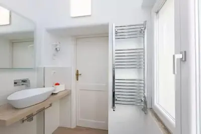 a white bathroom with a sink and a shower at Iron Apartment Santa Maria in Rome
