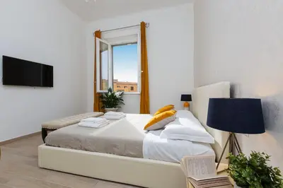 a bedroom with a large bed and a window at Iron Apartment Santa Maria in Rome