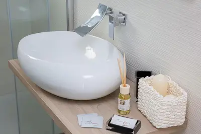 a white sink sitting on a table in a bathroom at Iron Apartment Santa Maria in Rome