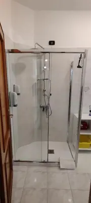 a shower with a glass door in a bathroom at Malagrino House in Rome