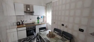 a small kitchen with a table and a table and chairs at Malagrino House in Rome