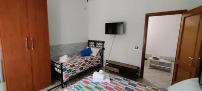 a small bedroom with two beds and a mirror at Malagrino House in Rome