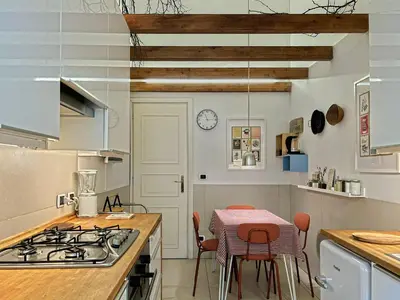 a kitchen with a stove and a table with chairs at Domus Trevis in Rome