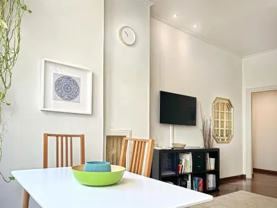 a dining room with a table and a tv at Domus Trevis in Rome