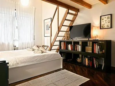 a bedroom with a bed and a book shelf with books at Domus Trevis in Rome