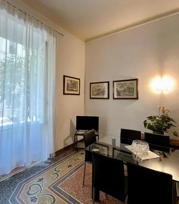 a living room with a glass table and a window at Vintage In Rome in Rome