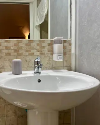 a white sink in a bathroom with a mirror at Vintage In Rome in Rome