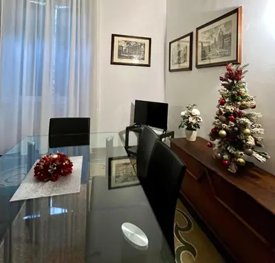 a dining room with a glass table and a christmas tree at Vintage In Rome in Rome