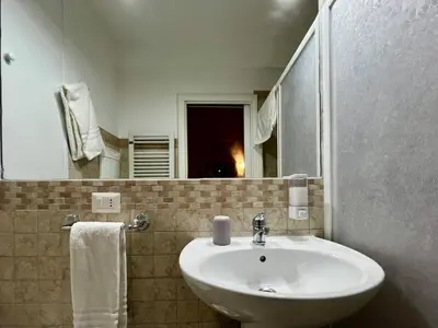 a bathroom with a white sink and a mirror at Vintage In Rome in Rome