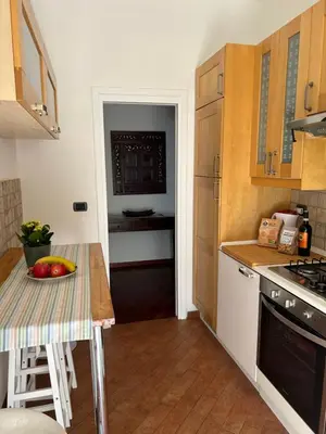 a kitchen with a table with a bowl of fruit on it at Holiday Rome Apartment in Rome