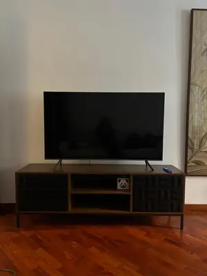 a flat screen tv sitting on top of a wooden entertainment center at Holiday Rome Apartment in Rome