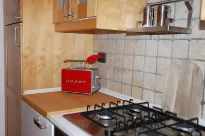 a kitchen with a red toaster sitting on a counter at Holiday Rome Apartment in Rome