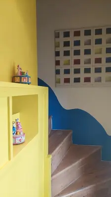 a childs room with a yellow staircase and wooden floors at Loft at Ponte Milvio in Rome