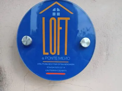 a blue sign with a house on it on a wall at Loft at Ponte Milvio in Rome
