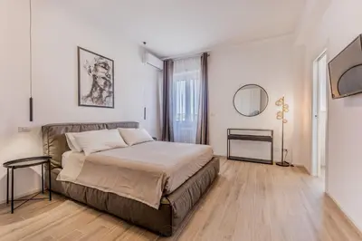 a bedroom with a large bed and a mirror at Domus Urbe Piramide in Rome