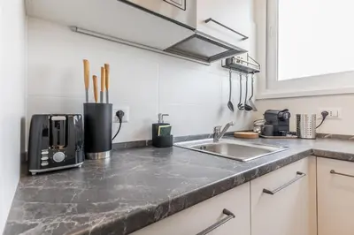 a kitchen counter with a sink and a microwave at Domus Urbe Piramide in Rome