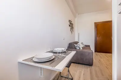 a living room with a table and a couch at Domus Urbe Piramide in Rome