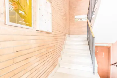 a staircase in a house with a brick wall at Domus Urbe Piramide in Rome