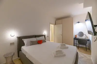 a bedroom with a bed with a red heart on it at Trastevere Luxury Apartment in Rome