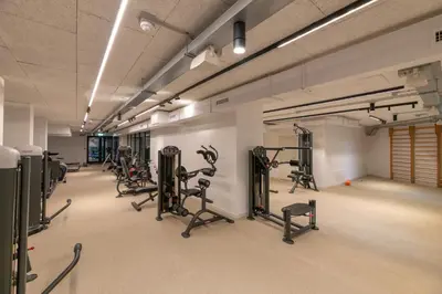 a gym with several treadmills and exercise bikes at Trastevere Luxury Apartment in Rome