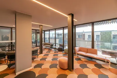 a lobby with a couch and chairs and windows at Trastevere Luxury Apartment in Rome