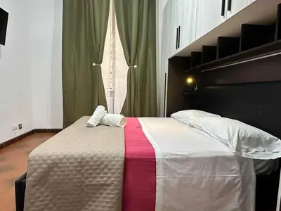 a bedroom with a bed with two towels on it at 888 Vittorio in Rome