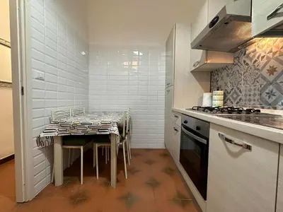 a kitchen with a table and a stove top oven at 888 Vittorio in Rome