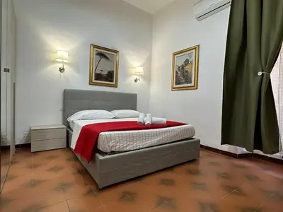 a bedroom with a bed with a red blanket at 888 Vittorio in Rome