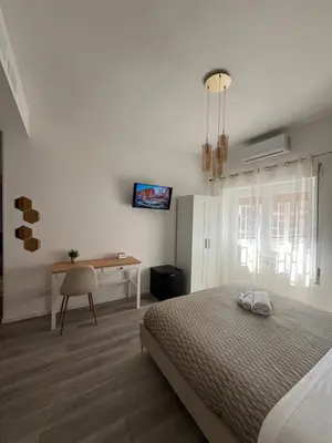 a bedroom with a bed and a desk in it at Tiburtina Urban Rooms in Rome