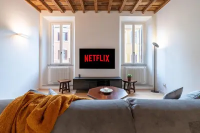 a living room with a couch and a tv at Sotto al letto del Papa - Borgo Pio - Vaticano in Rome