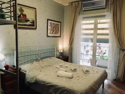 a bedroom with a bed with a ladder and a window at A casa di Simone in Rome