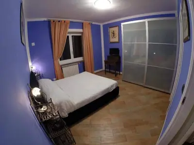 a blue bedroom with a bed and a window at A casa di Simone in Rome
